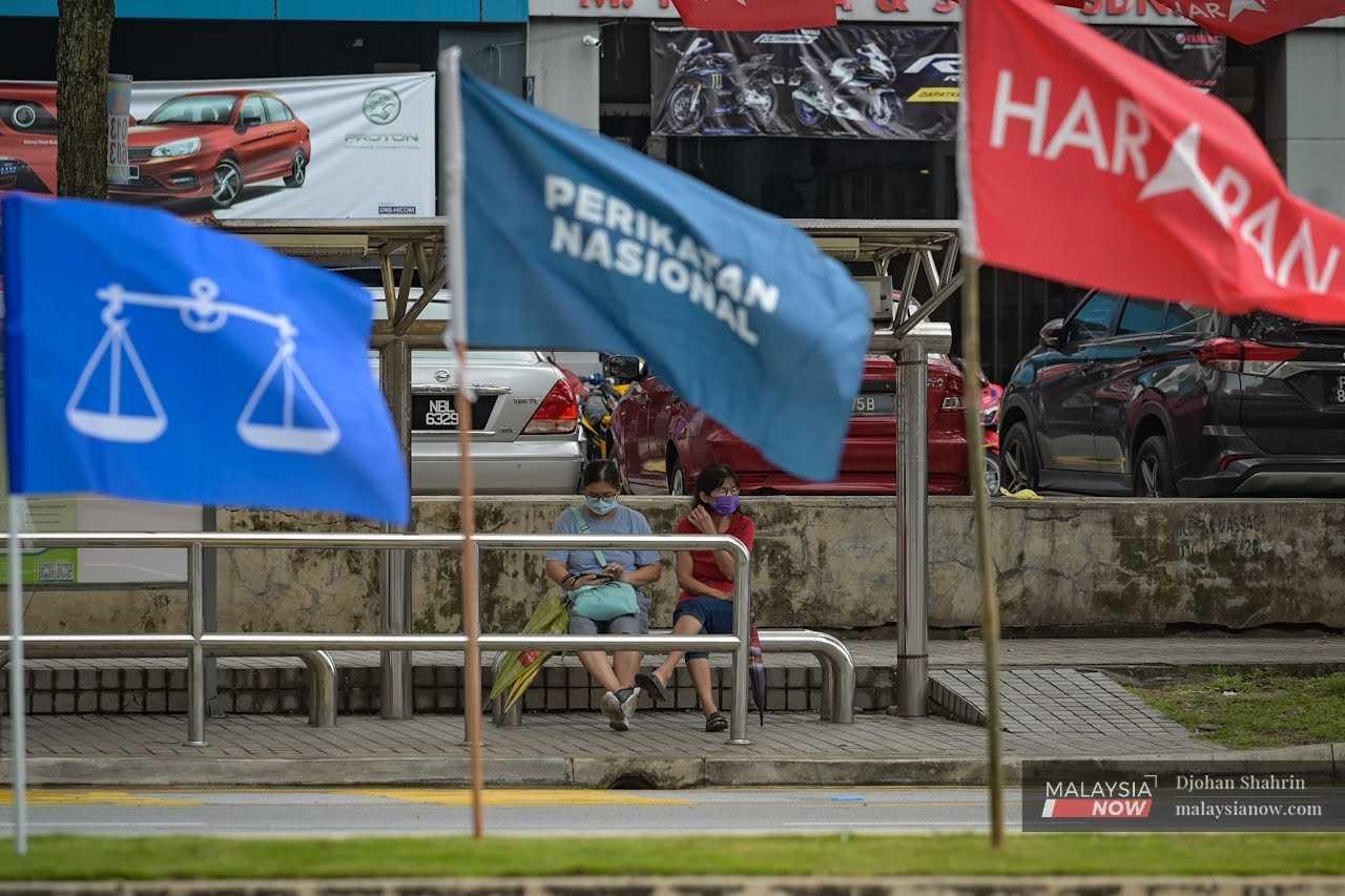 The flags of the country's three major political coalitions – Barisan Nasional, Perikatan Nasional and Pakatan Harapan – wave at a bus stop in Tasik Permaisuri, Cheras ahead of last year's general election.
