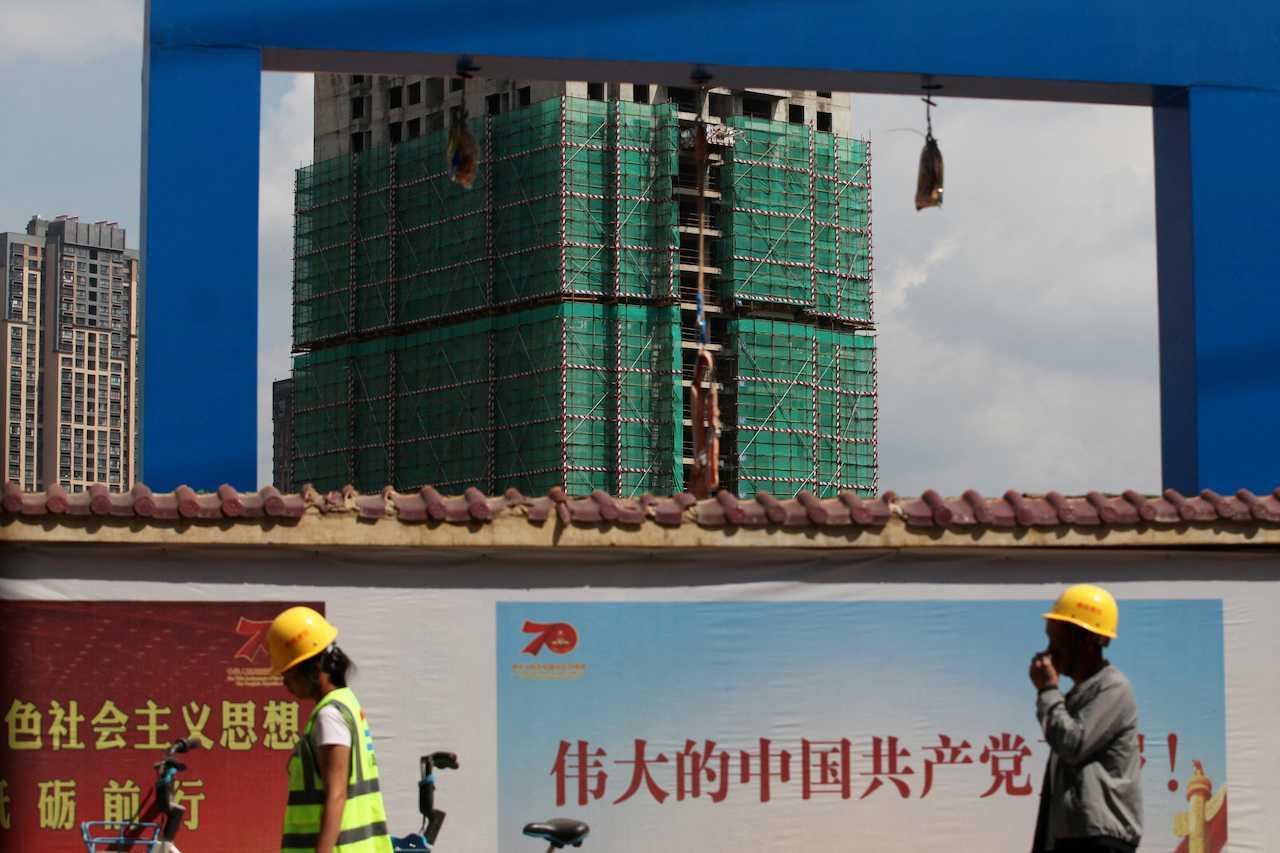 Workers walk past a construction site of residential buildings by property developer Country Garden in Kunming, Yunnan province, China, Sept 17, 2019. Photo: Reuters