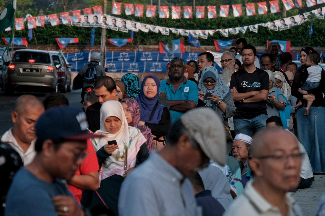 Voters wait to cast their ballots outside an election centre in Kuala Lumpur during the 14th general election on May 9, 2018. A recnt survey has found that many youth have no interest in participating in politics. Photo: AP