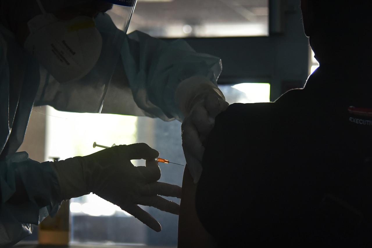 A medical worker administers a dose of Covid-19 vaccine at the International Ferry Terminal vaccination centre in Labuan. Photo: Bernama