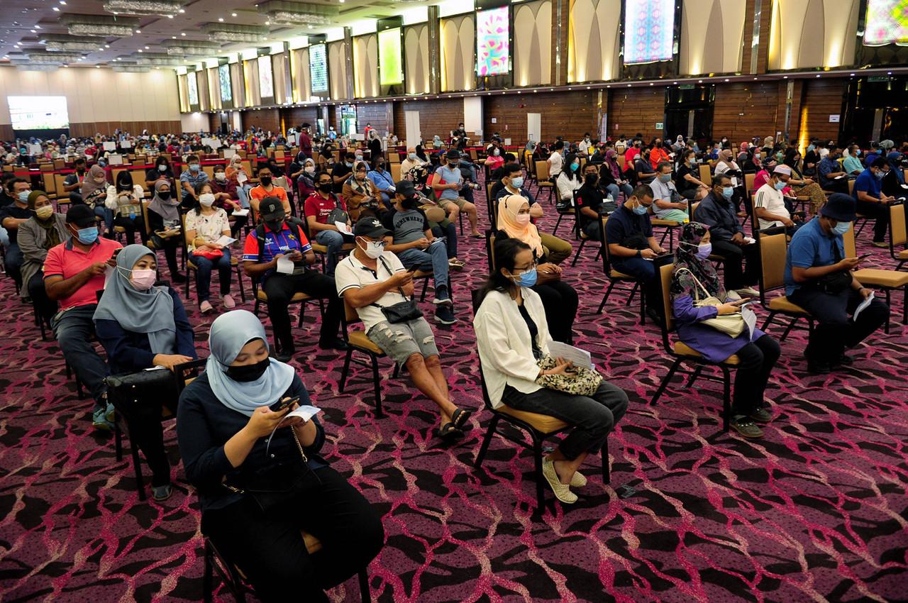 People wait for their turn to be vaccinated at the IDCC vaccination centre in Shah Alam. Photo: Bernama