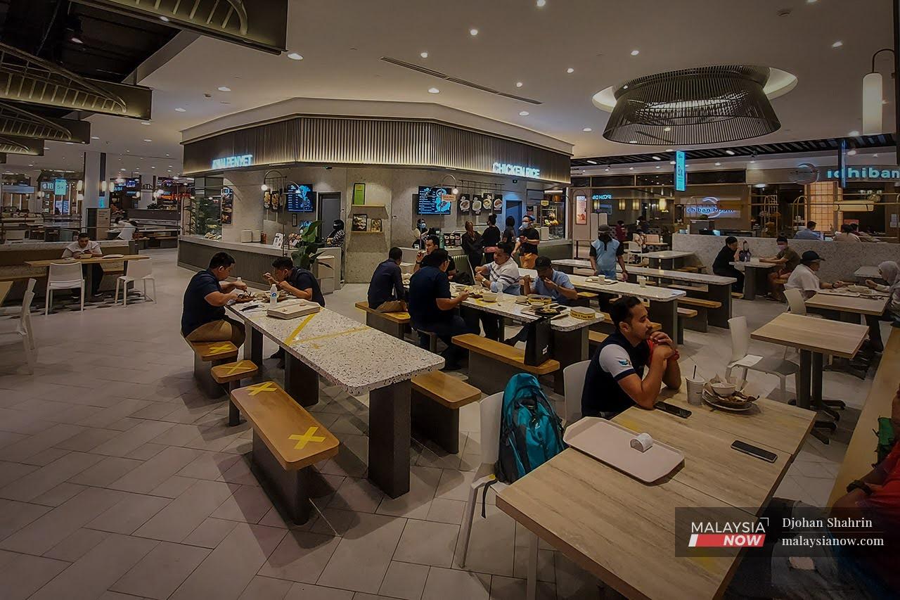Fully vaccinated people enjoy a quick meal at the food court of a mall in Bukit Bintang, Kuala Lumpur.