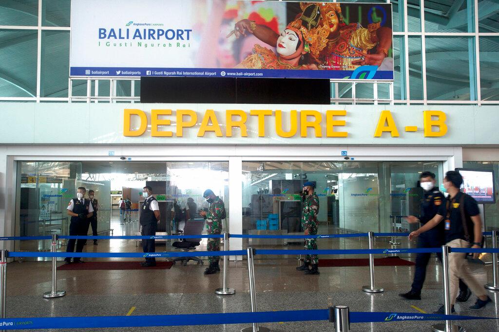Workers stand guard at a departure gate during a dry run for the reopening of the Ngurah Rai International airport in Bali, Indonesia, Oct 9. Photo: AP