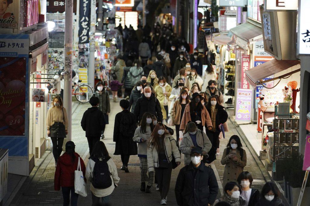 People wearing protective masks to help curb the spread of the coronavirus walk at a shopping street in Tokyo, Japan. Concerns over Japan's fragile recovery have prompted the government to unveil a record US$490 billion spending package earlier this month, bucking a global trend towards withdrawing crisis-mode stimulus measures. Photo: AP
