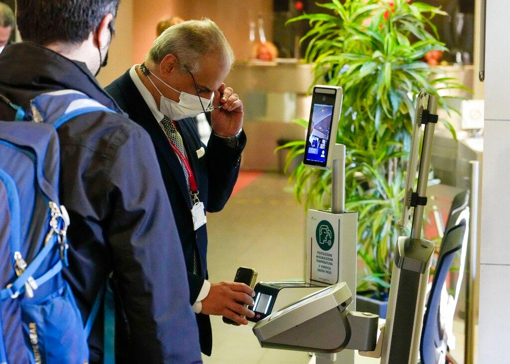 An employee has his certification checked as Italy's 'Green Pass' vaccination requirement for employees to enter their offices became mandatory, at the Trenitalia, Italian train company offices, in Rome, on Oct 15. Photo: AP