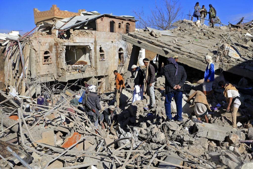 Yemenis inspect the damage following overnight air strikes by the Saudi-led coalition targeting the Huthi rebel-held capital Sanaa, on Jan 18. Photo: AFP