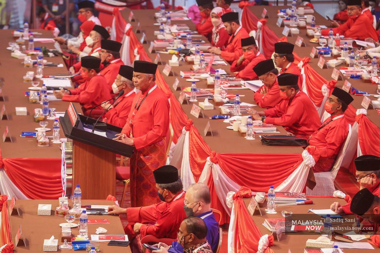 Umno president Ahmad Zahid Hamidi stands as he delivers his speech during the Umno general assembly at the World Trade Centre in Kuala Lumpur today.