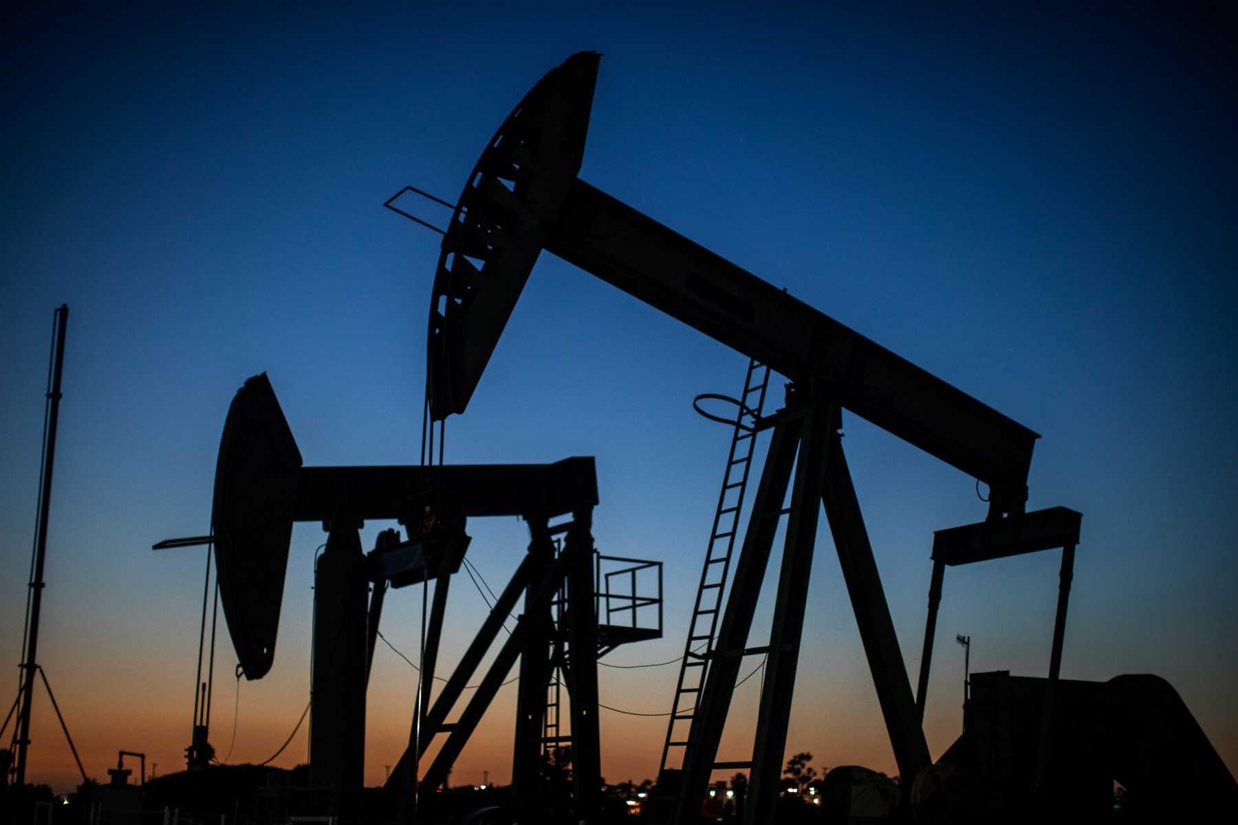 Oil pumpjacks operate at dusk Willow Springs Park in Long Beach, California on April 21, 2020. The US oil futures benchmark, West Texas Intermediate for delivery in August, finished below US$100 a barrel for the first time in around two months, falling 8.2% to US$99.50 a barrel. Photo: AFP 