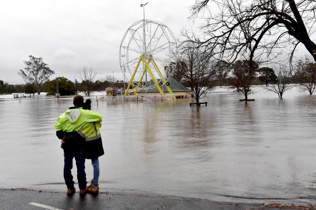 People look at a flooded park due to torrential rain in the Camden suburb of Sydney on July 3. Photo: AFP