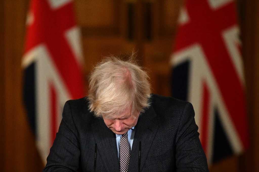 In this file photo taken on Jan 26, 2021, Britain's Prime Minister Boris Johnson looks down at the podium as he attends a virtual press conference inside 10 Downing Street in central London. Photo: AFP