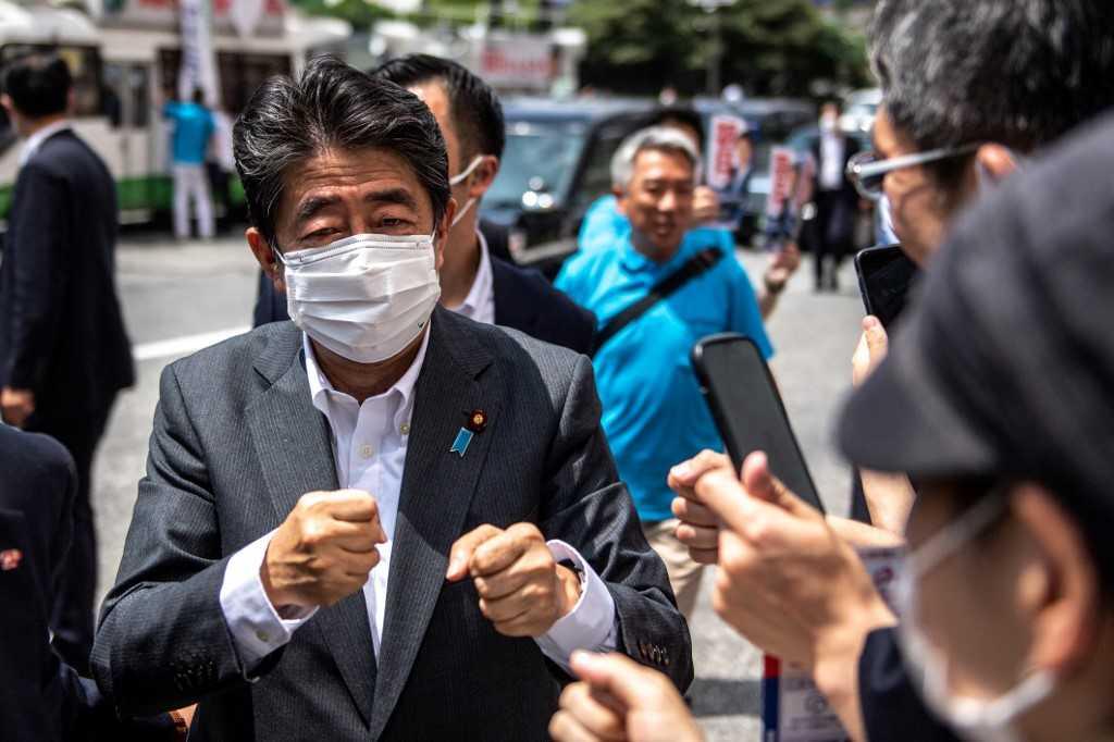 Former Japanese prime minister Shinzo Abe interacts with supporters as he joins the election campaign for Liberal Democratic Party member Kentaro Asahi (not pictured) ahead of the House of Councillors election on July 10, in Tokyo on June 22. Photo: AFP