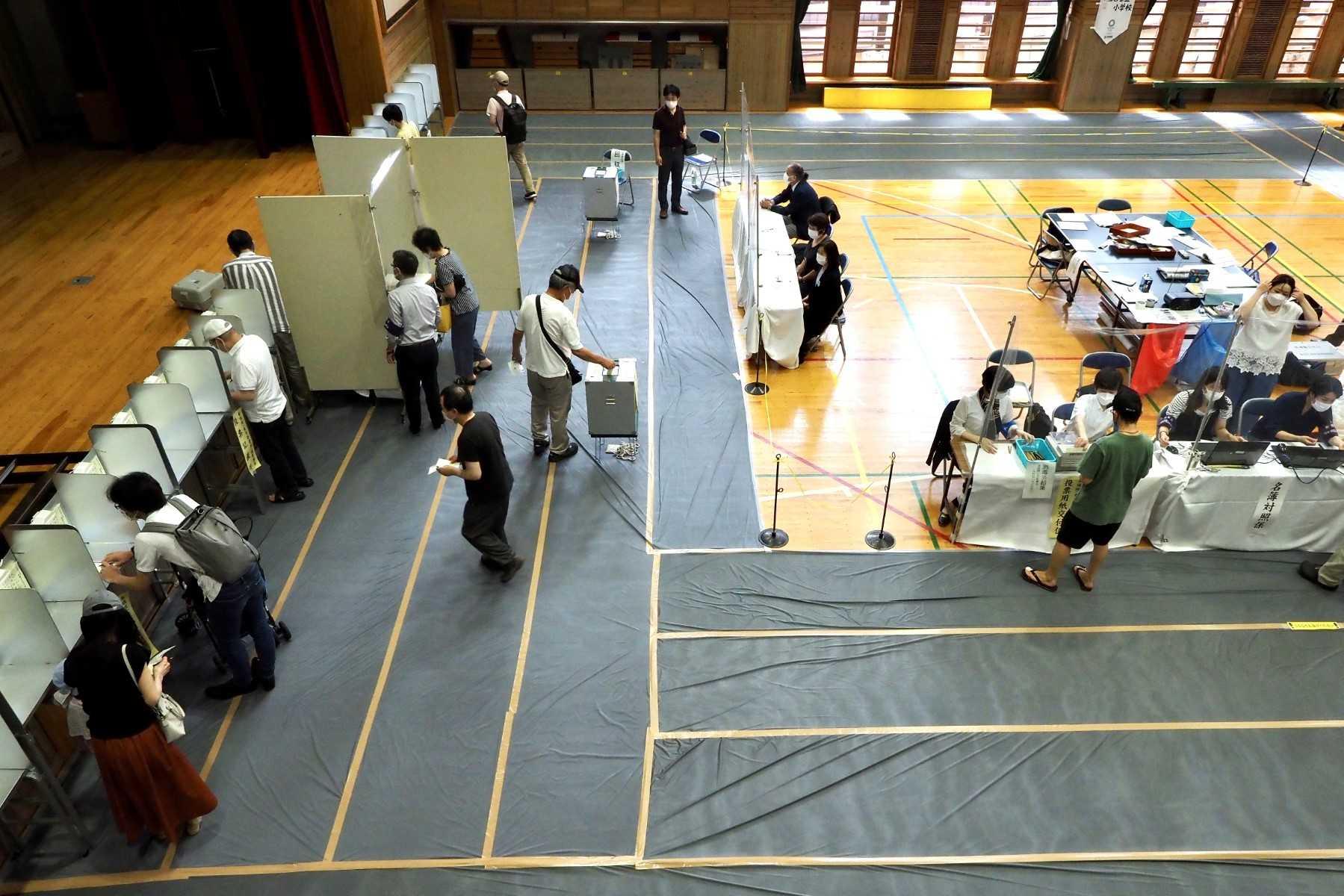 People vote during Japan's upper house elections at a polling station in Tokyo on July 10. Photo: AFP