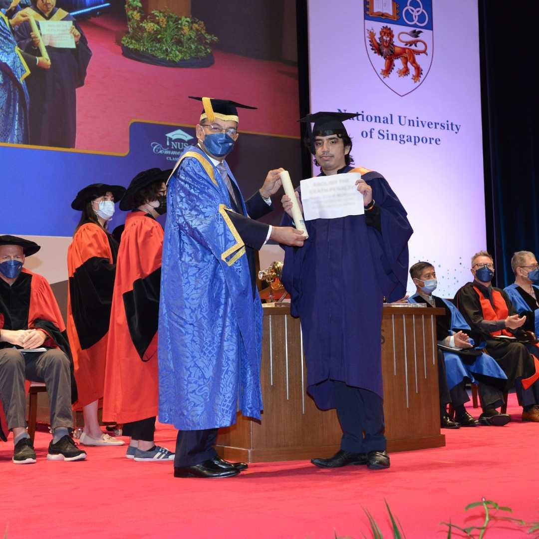 Luke Levy's protest sign blurred in his official graduation picture.
