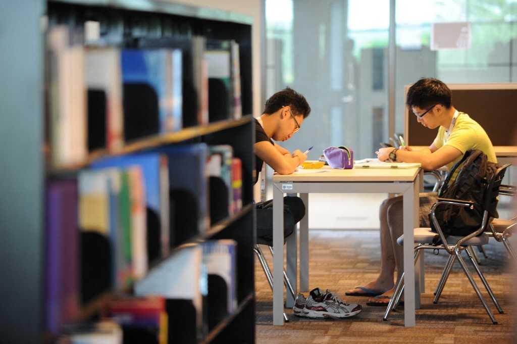 Students work in the library of a university in Johor. Research work at public universities traditionally relied on government grants and funding. Photo: AFP
