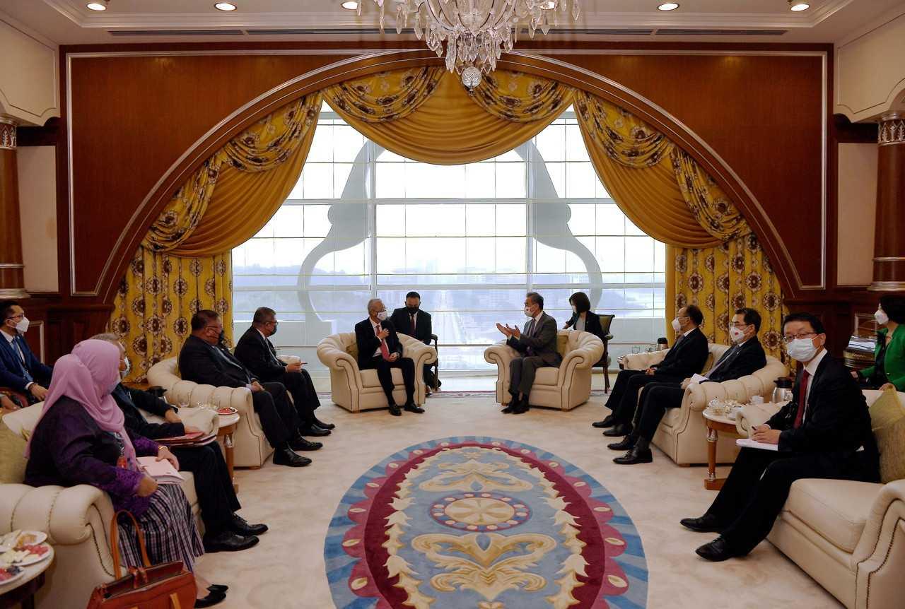Prime Minister Ismail Sabri Yaakob receives Chinese Foreign Minister Wang Yi during a courtesty visit at Perdana Putra in Putrajaya today. Photo: Bernama
