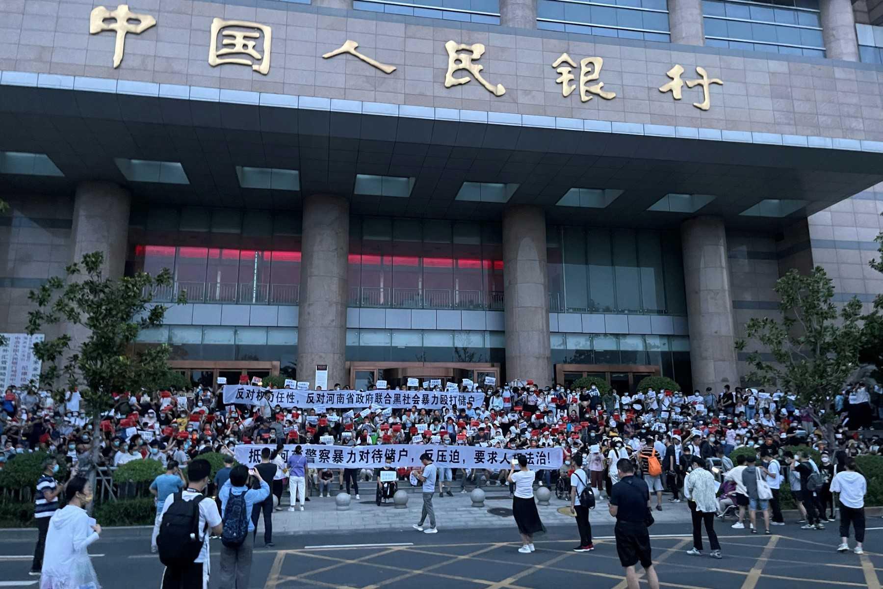 This handout photo taken on July 10, and released by an anonymous source shows people protesting in front of a branch of the People's Bank of China in the central Chinese city of Zhengzhou. Photo: AFP