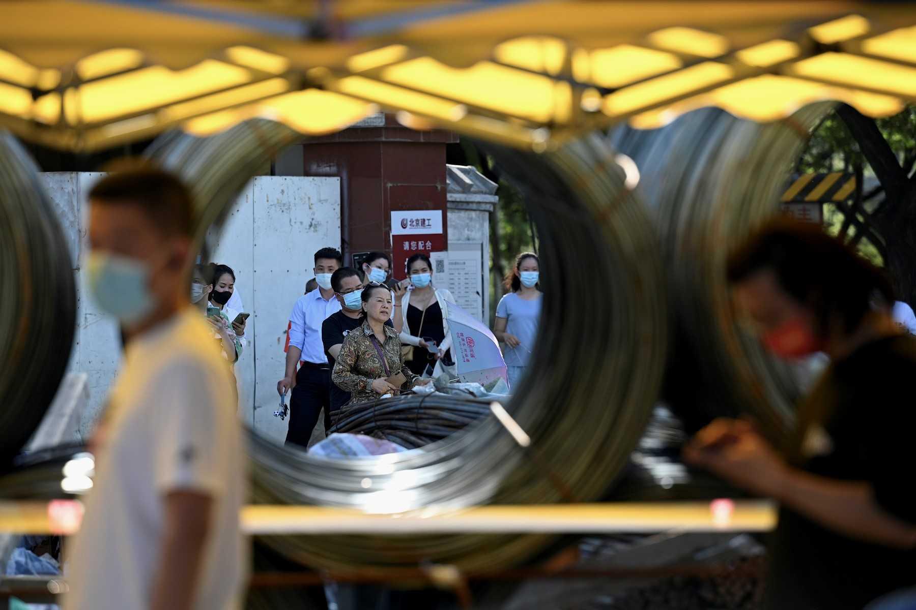 People queue to be tested for Covid-19 at a swab collection site in Beijing on July 7. Photo: AFP