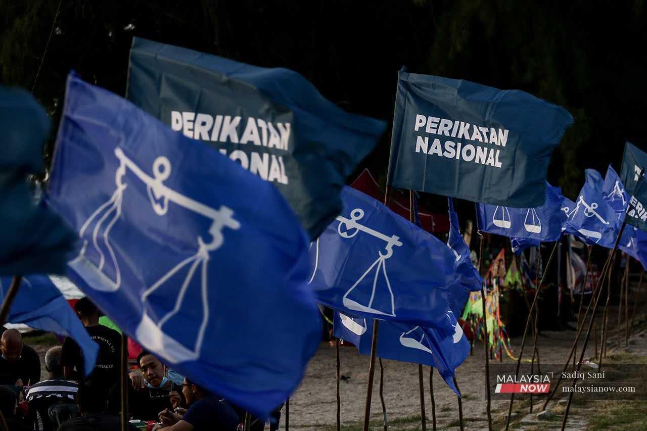 The flags of Barisan Nasional and Perikatan Nasional flutter in the breeze at Pantai Puteri ahead of the Melaka state election last November.