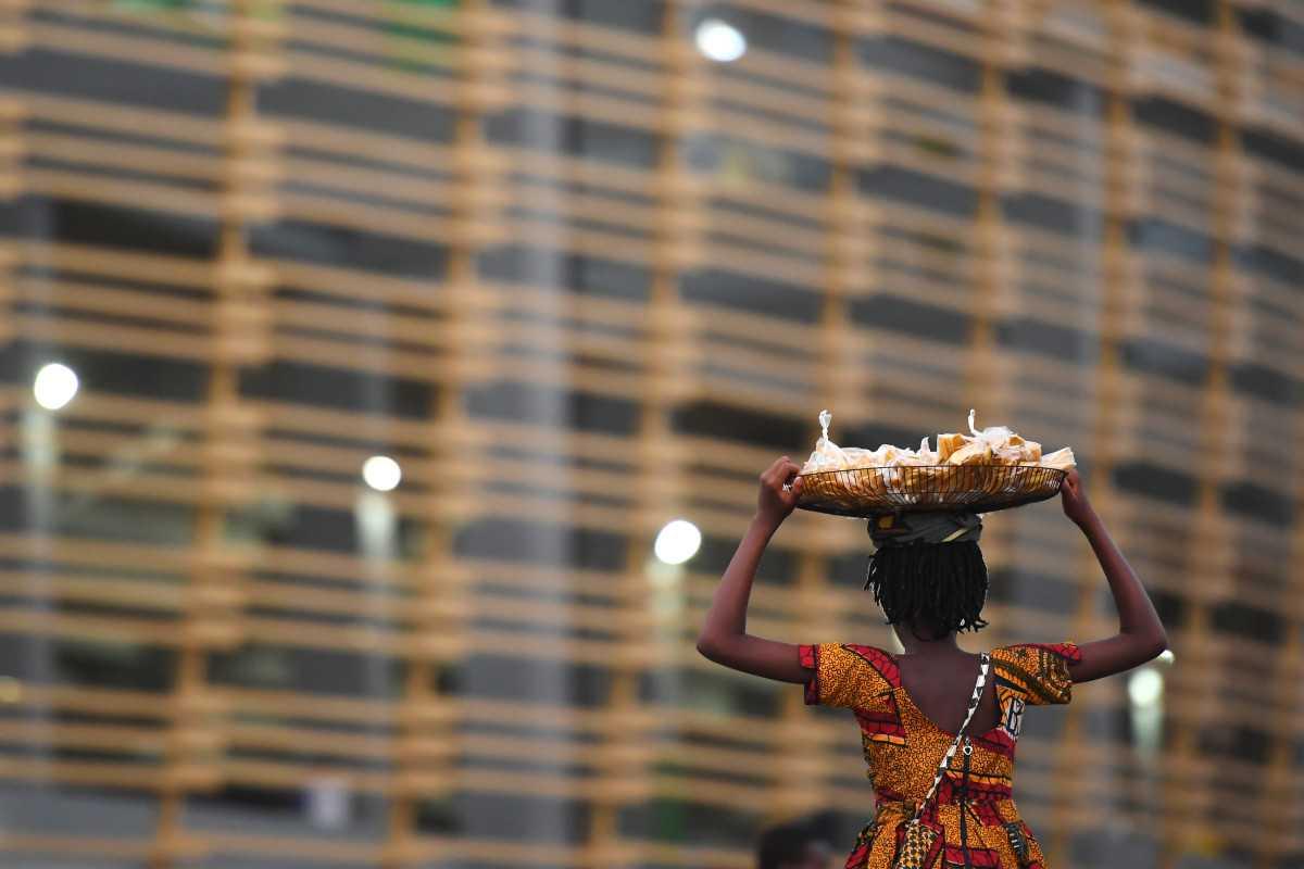 A street vendor walks outside a stadium in Port-Gentil on Jan 25, 2017. Marburg is transmitted to people from fruit bats and spreads among humans through direct contact with the bodily fluids of infected people, surfaces and materials, the WHO says. Photo: AFP