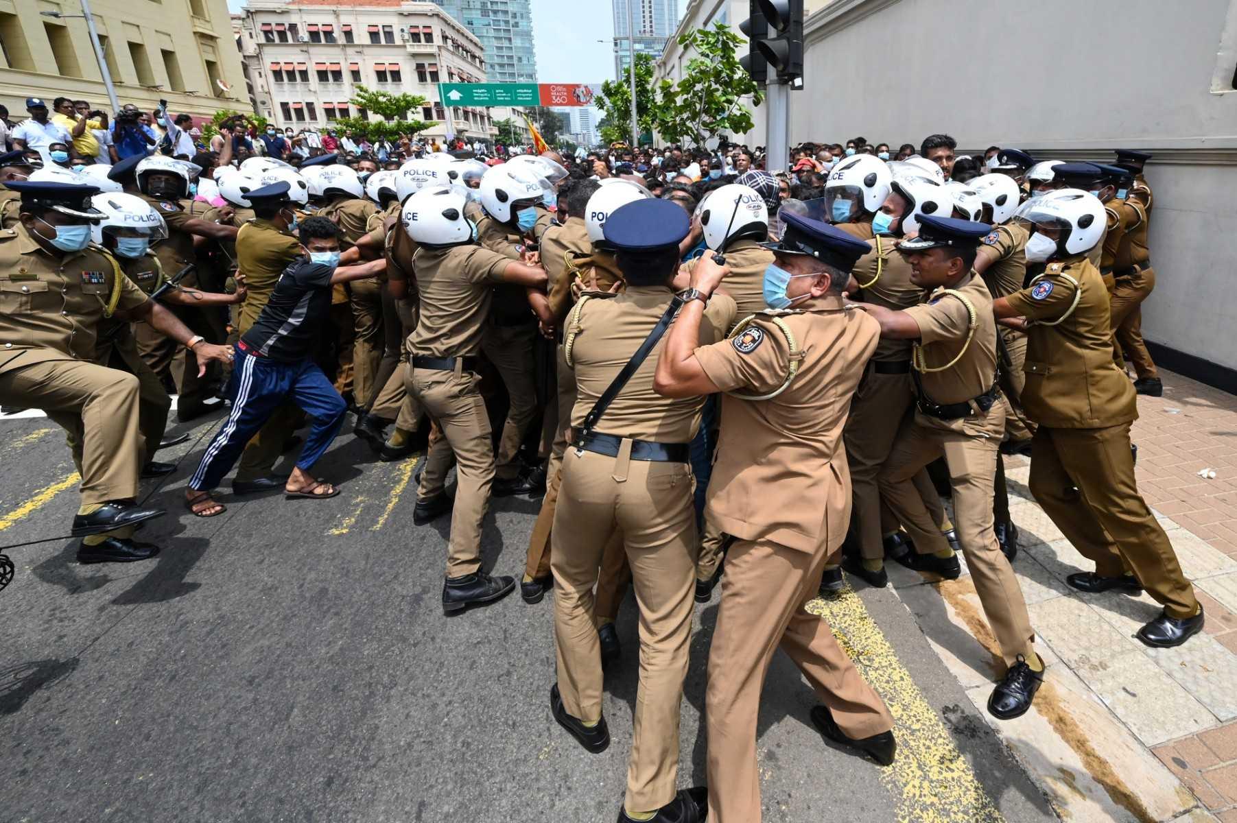 Government supporters and police clash outside the president's office in Colombo on May 9. Photo: AFP