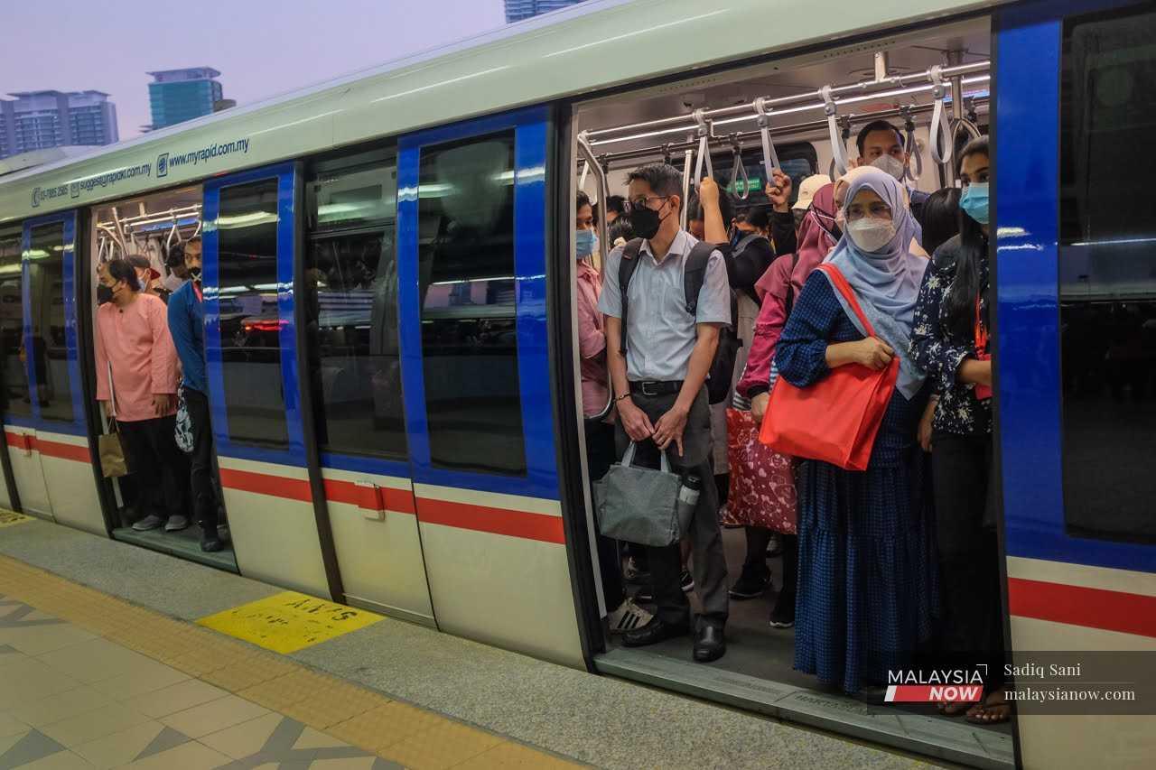 Office workers cram into an LRT in Kuala Lumpur after a day of work in the capital city.