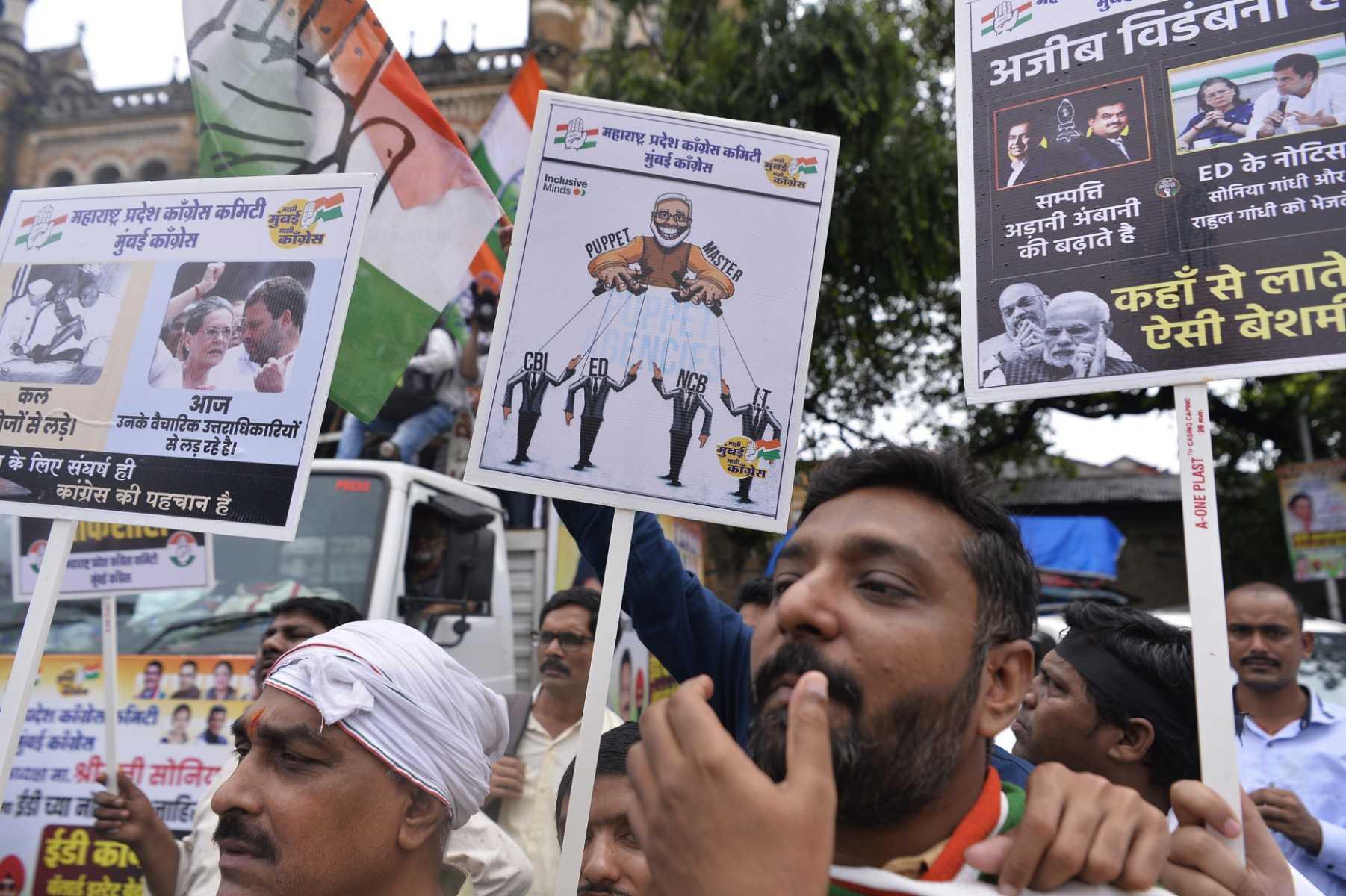 Congress party activists hold placards during a protest against the Enforcement Directorate for the questioning of party leader Sonia Gandhi in an alleged money laundering case, in Mumbai on July 21. Photo: AFP