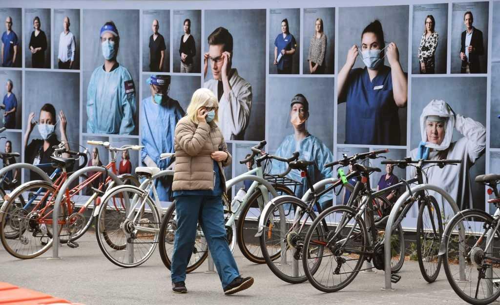 A woman walks past a display of photos outside the Royal Melbourne Hospital to thank healthcare workers in this on Oct 20, 2020 file photo. Photo: AFP