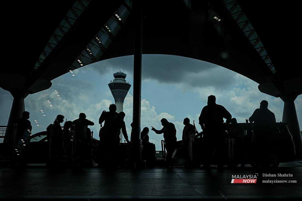 Travellers mill about at the entrance of KLIA in Sepang. The health ministry says surveillance for monkeypox symptoms has been stepped up at the country's international entry points.
