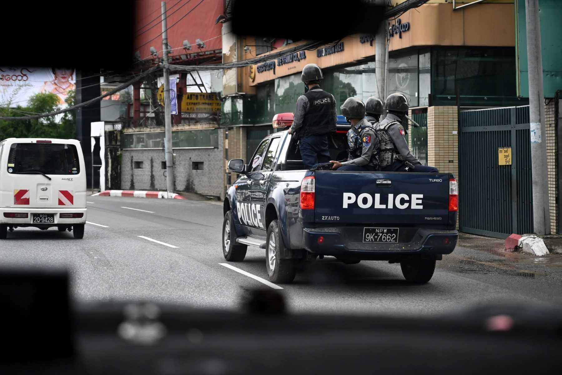 Police patrol on a street in Yangon on July 19. Photo: AFP
