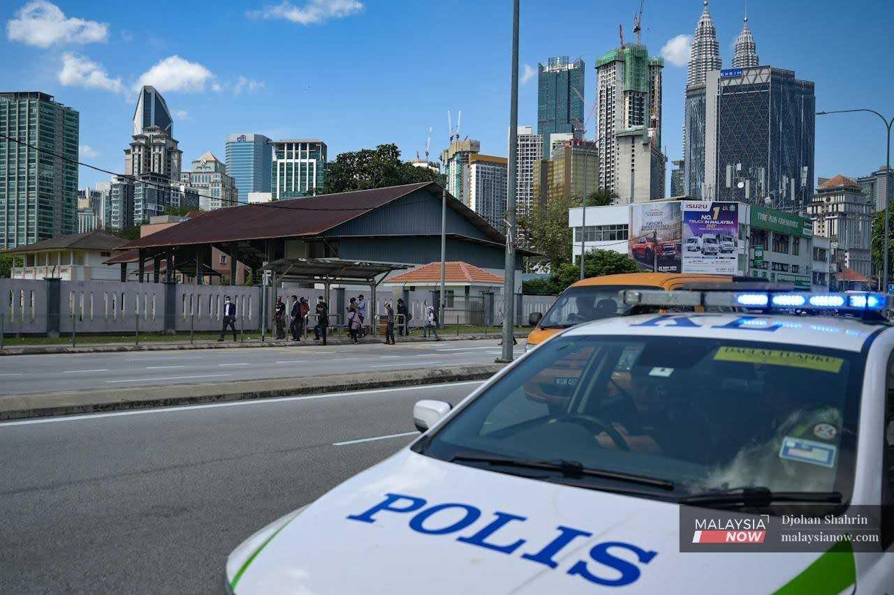 A police patrol car makes the rounds in the capital city of Kuala Lumpur. 
