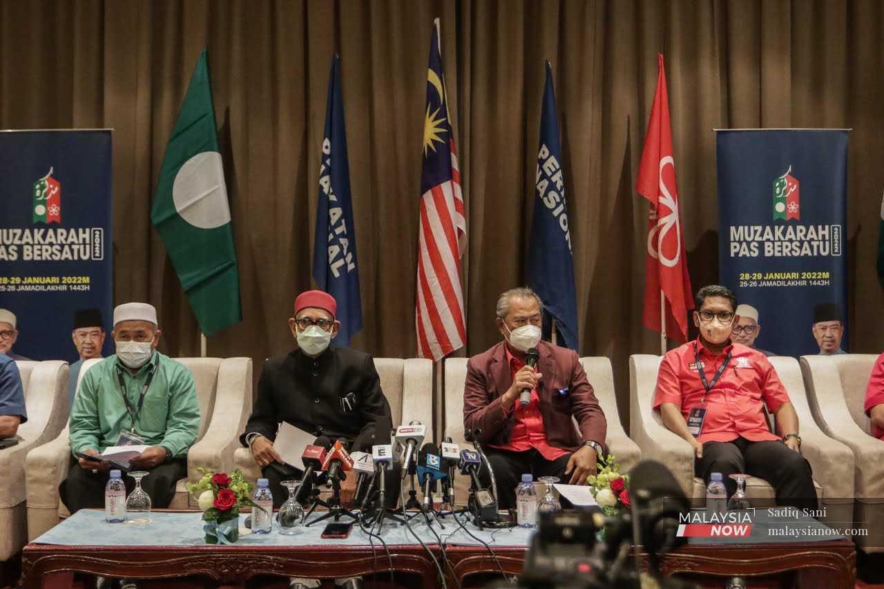 PAS president Abdul Hadi Awang (second left) with Bersatu president Muhyiddin Yassin (second right) at a press conference on the Johor state election in January. 
