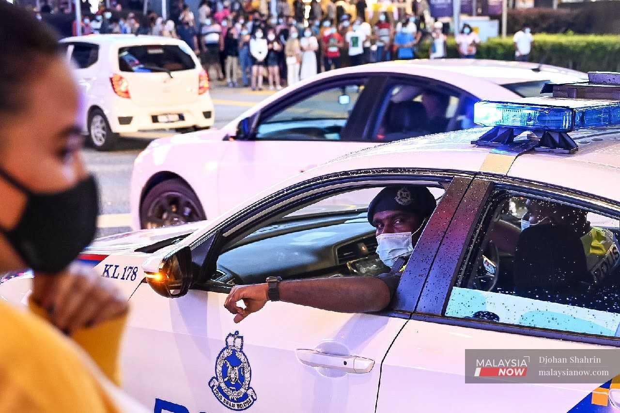 A police patrol car makes the rounds in Bukit Bintang, Kuala Lumpur. 