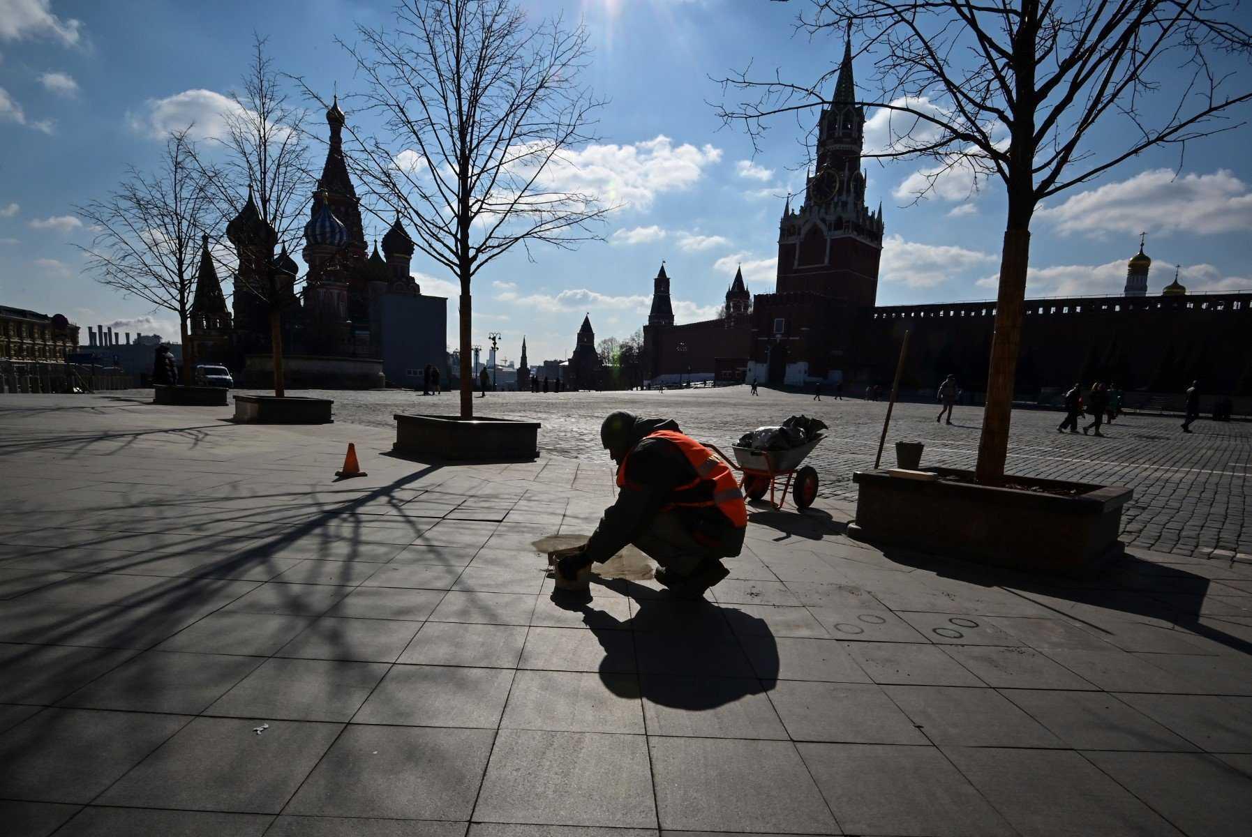 A worker fixes paving tiles at Red Square in central Moscow on March 16. Photo: AFP