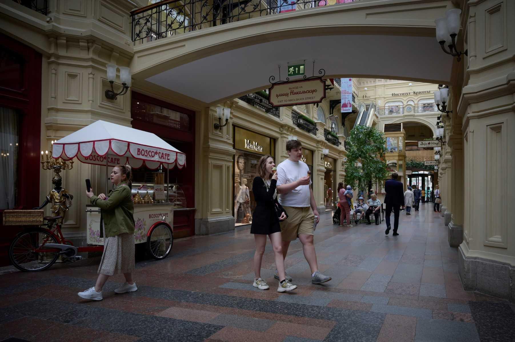 Customers walk at the GUM department store near Red Square in Moscow on June 20. Photo: AFP