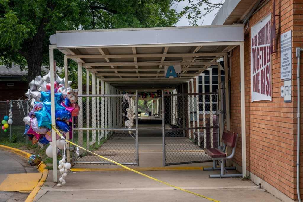 Balloons and caution tape displayed at the entrance to Robb Elementary School on May 31 in Uvalde, Texas, where 19 students and two teachers were killed in a massacre. Photo: AFP