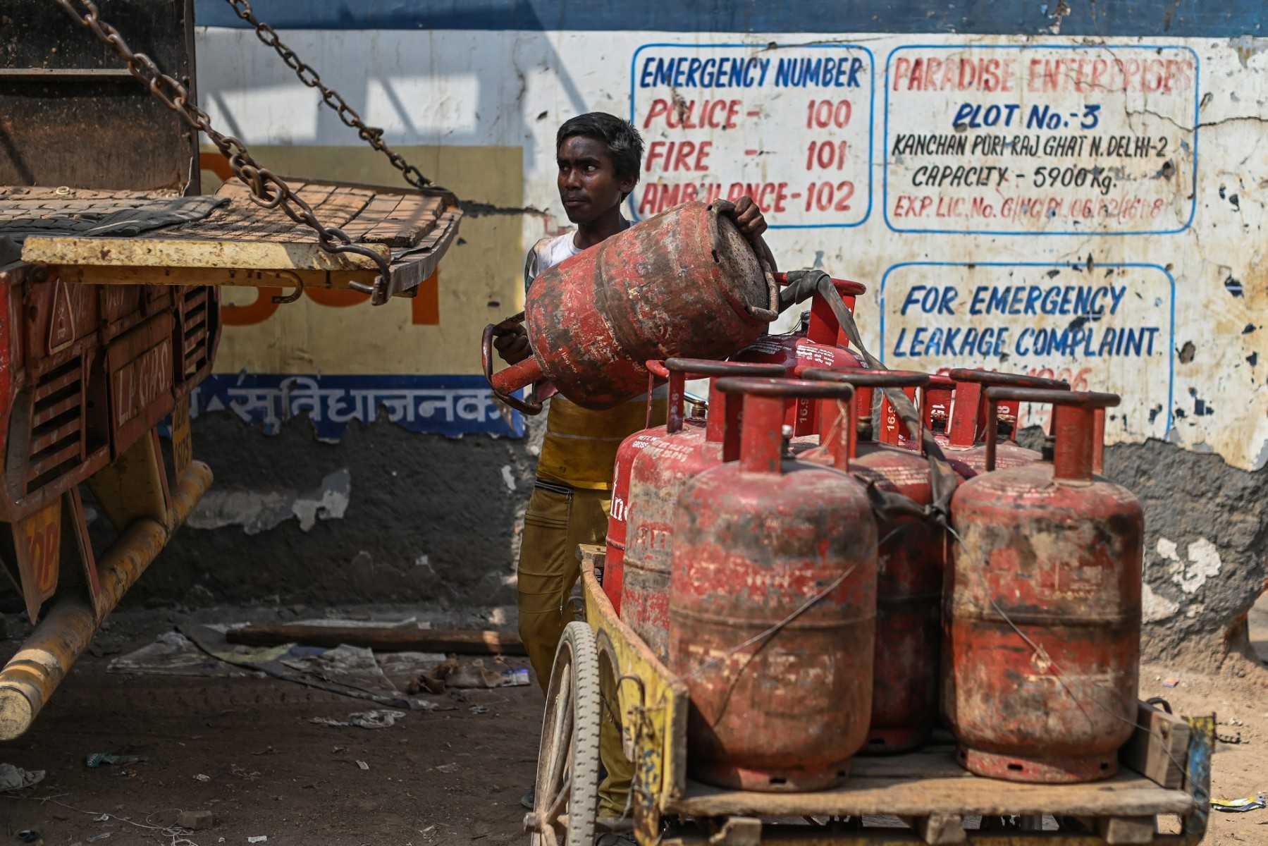 A worker loads an empty liquified petroleum gas cylinder onto a truck near a depot in New Delhi on May 9. Photo: AFP