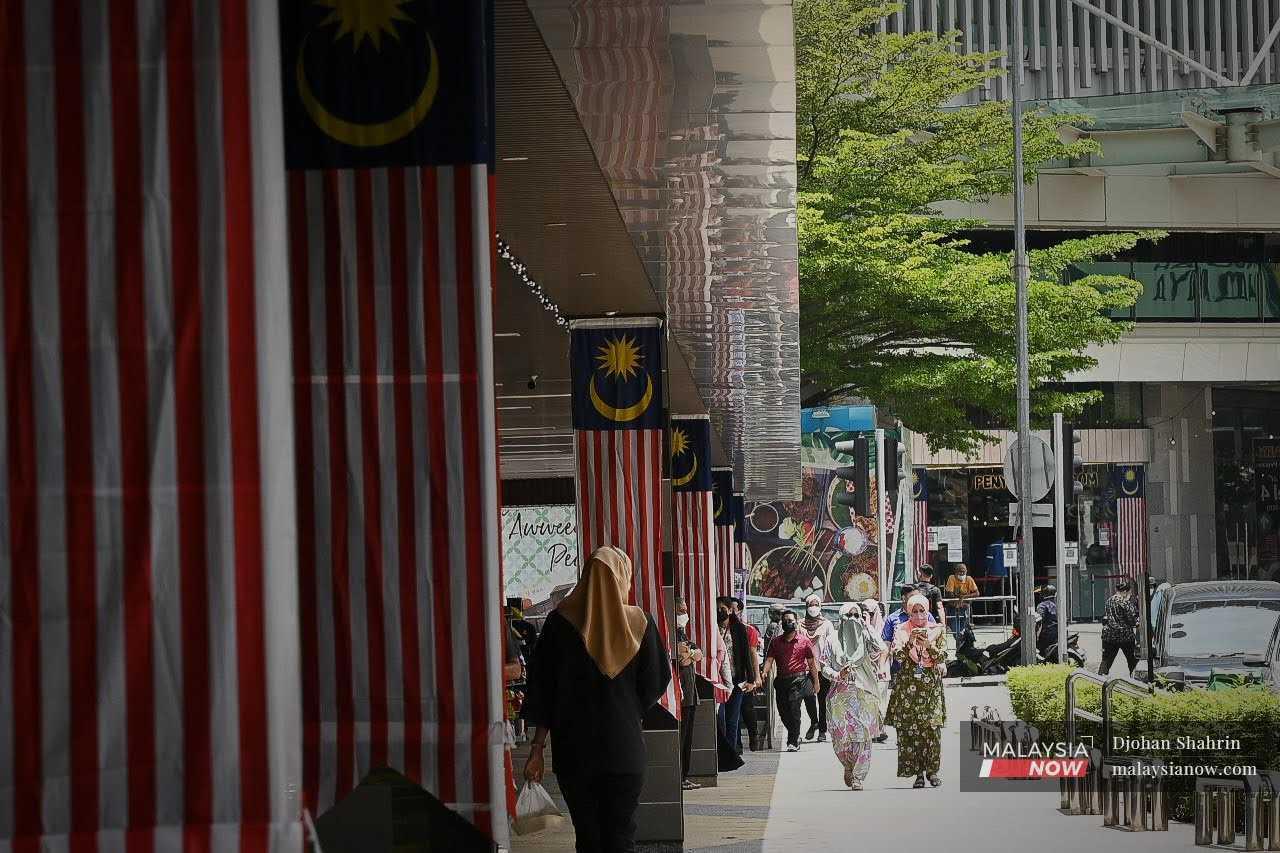 Pedestrians pass a row of buildings in Jalan Tuanku Abdul Rahman in Kuala Lumpur.