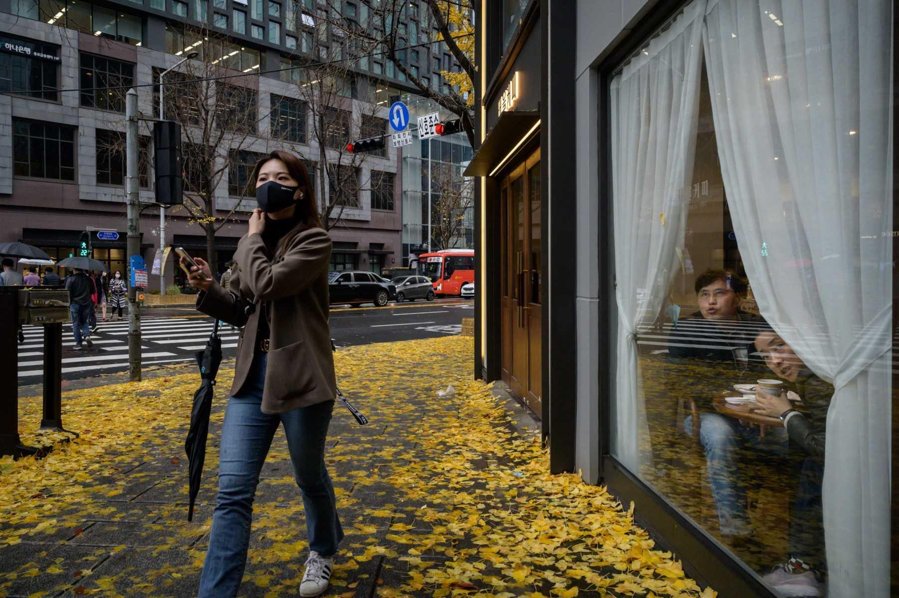 A pedestrian wearing a face mask crosses a street in Seoul on Nov 19, 2020. Photo: AFP
