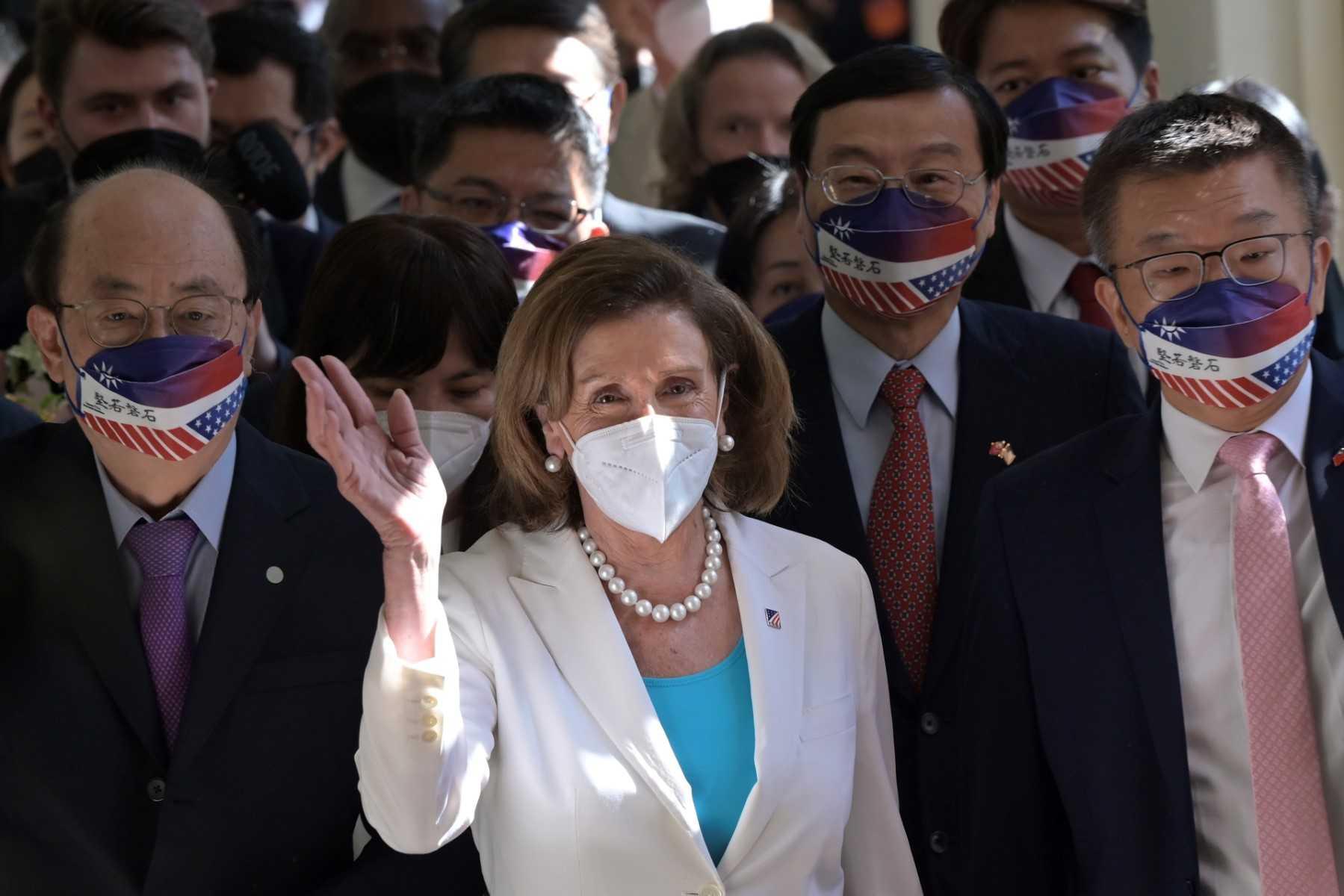 Visiting US House Speaker Nancy Pelosi (centre) waves to journalists during her arrival at the Parliament in Taipei on Aug 3. Photo: AFP
