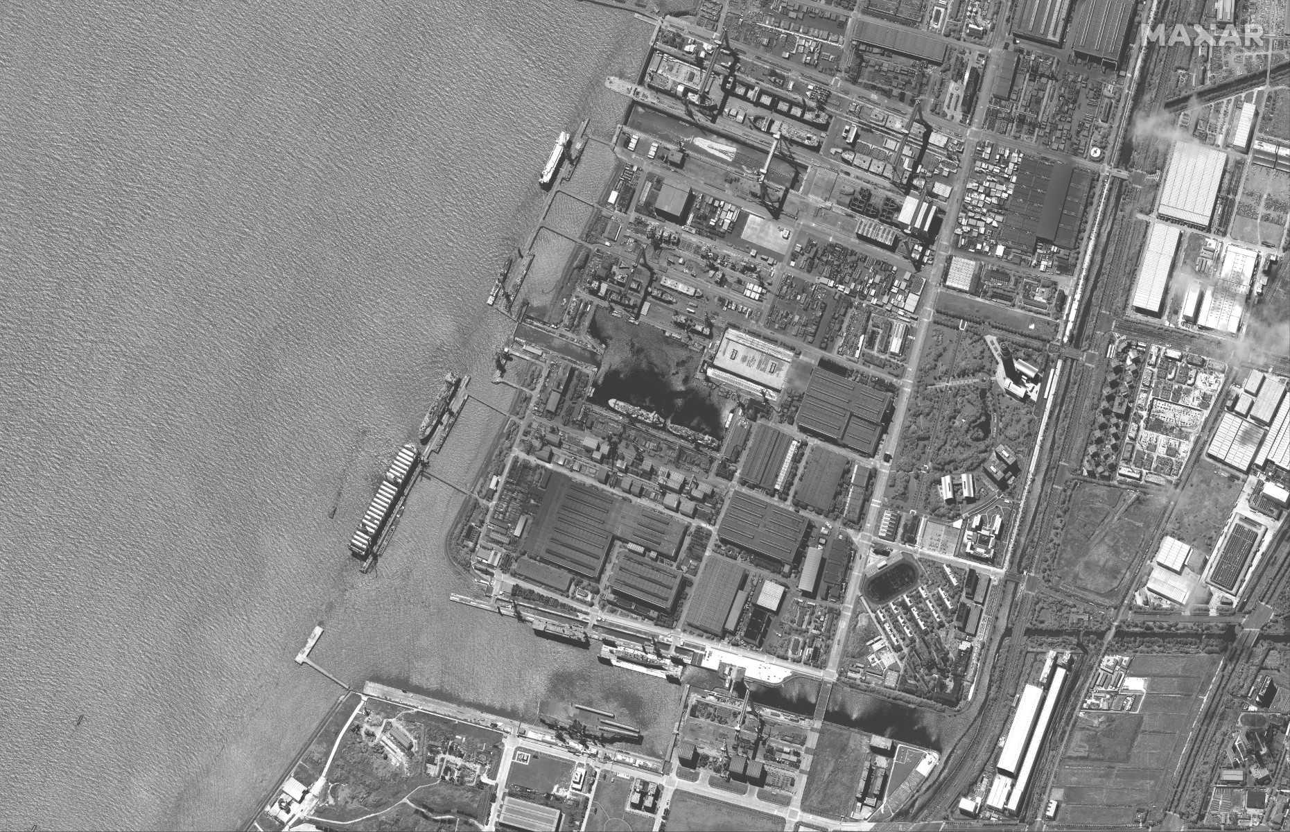 This handout satellite image taken by Maxar Technologies on June 18, shows the new location of the Fujian (bottom C), China's third aircraft carrier, following her launch from the dry dock (top C) where the ship was constructed at the Jiangnan shipyards in Shanghai. Photo: AFP 