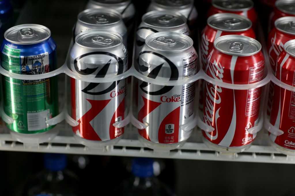 Coke cans sit on a store shelf on Dec 9, 2013. Photo: AFP