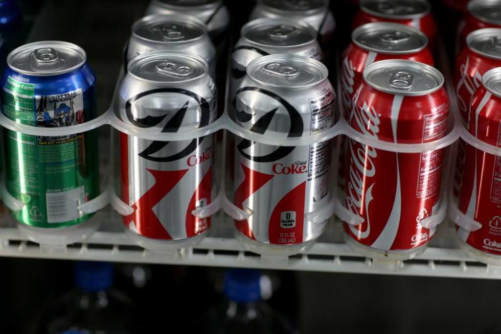 Coke cans sit on a store shelf on Dec 9, 2013. Photo: AFP 