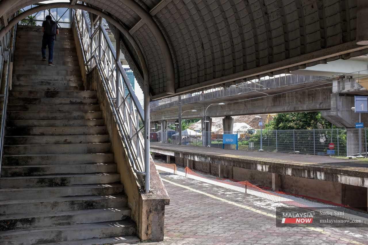 A commuter takes the stairs at the Seputeh KTM Komuter station in Kuala Lumpur.