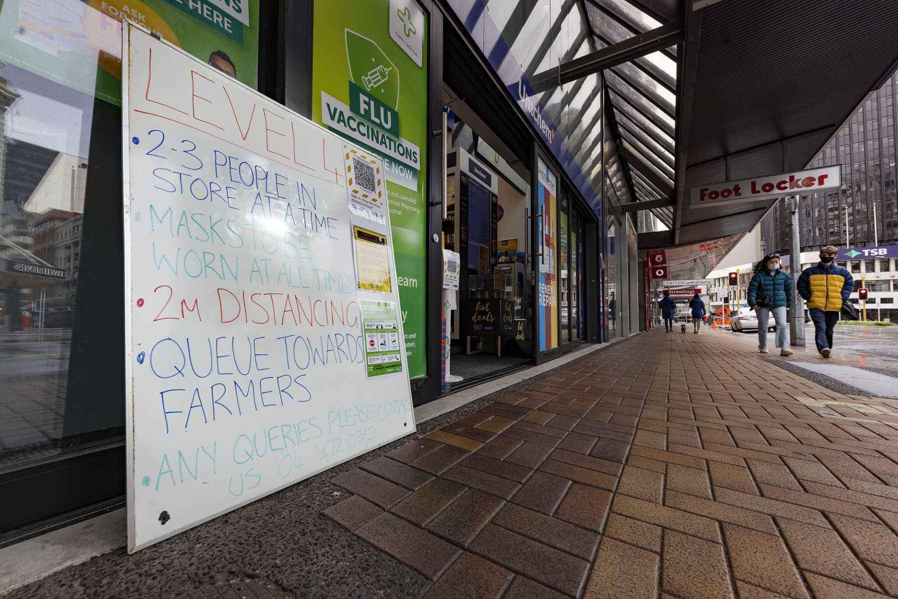 A sign stating Covid-19 preventive measures is displayed outside a pharmacy during a nationwide lockdown in Wellington on Aug 18, 2021. Photo: AFP