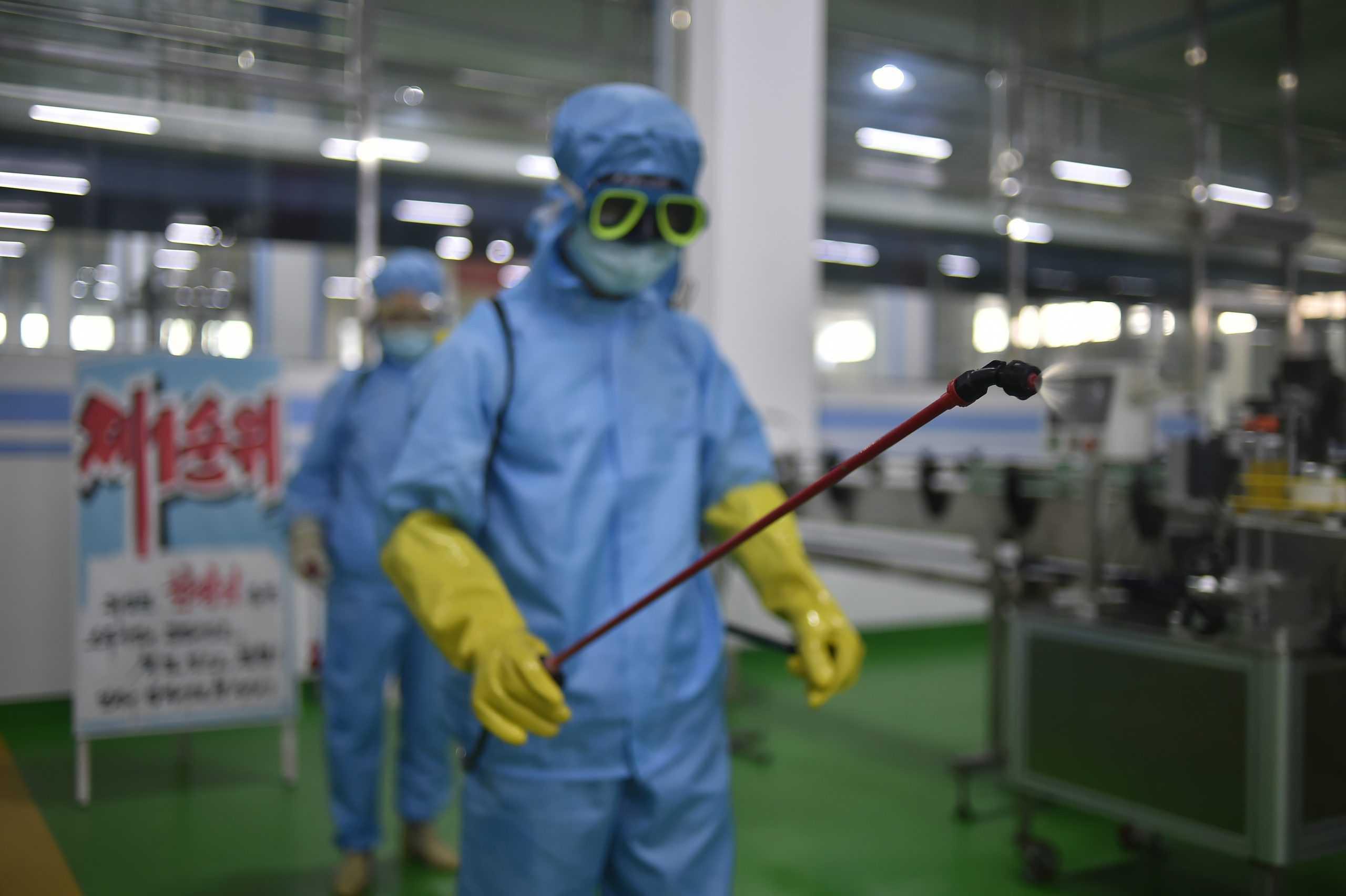 A health official disinfects the floor inside the Ryongaksan soap factory in Pyongyang on June 13. Photo: AFP