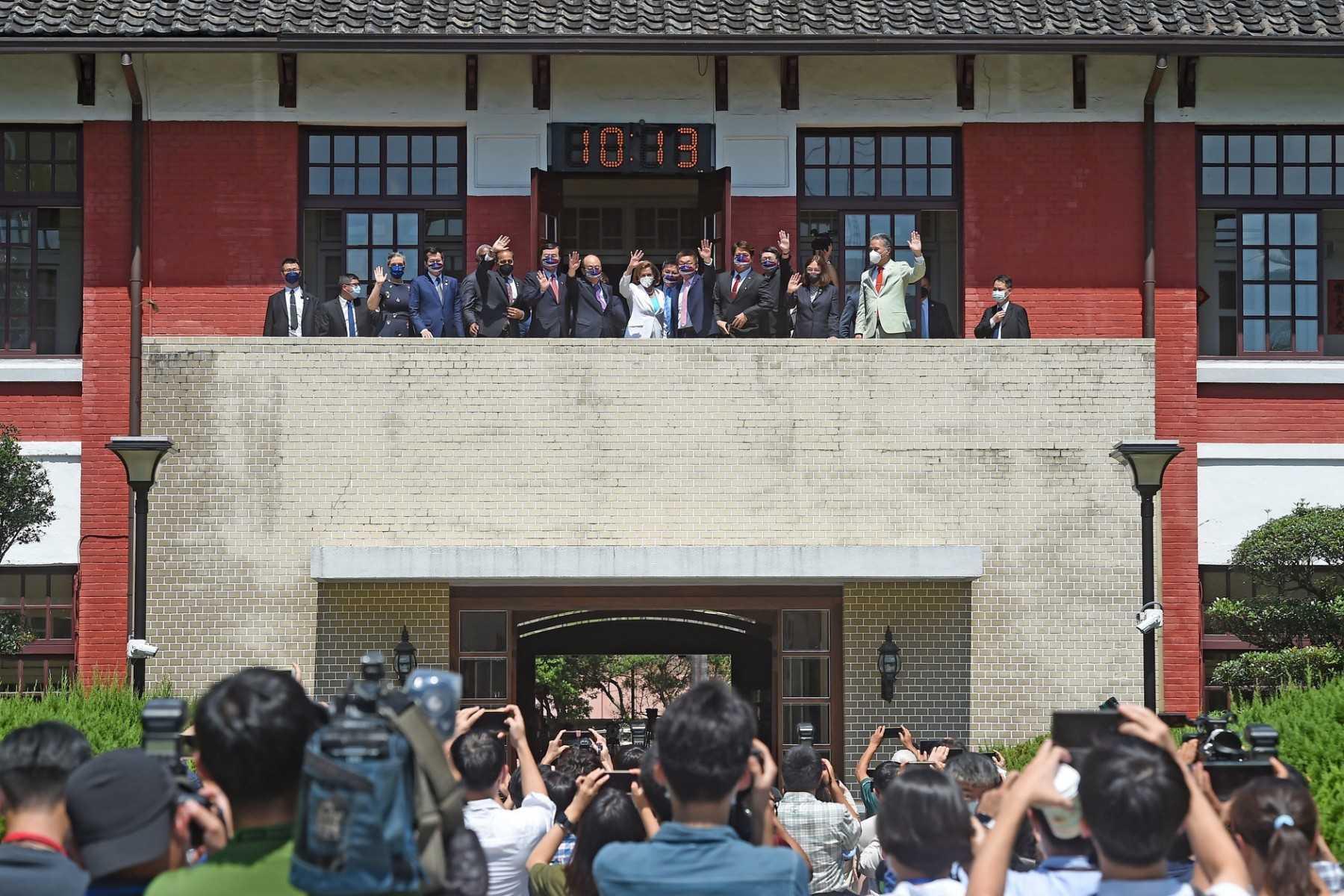 This picture taken by Taiwan’s Central News Agency shows US House Speaker Nancy Pelosi (top centre) and other officials waving to journalists at the Parliament in Taipei on Aug 3. Photo: AFP