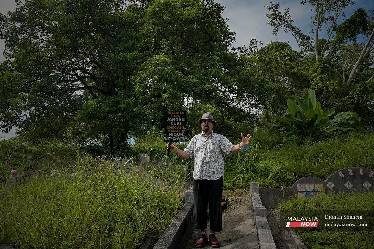 Hishamuddin stands beside another message about the coexistence of humans and the animals which lose their habitats due to development. 