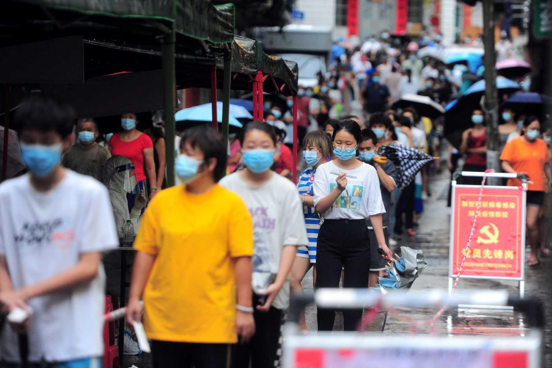 Residents and tourists queue to undergo nucleic acid tests for the Covid-19 coronavirus in Sanya in China's southern Hainan province on Aug 8. Photo: AFP