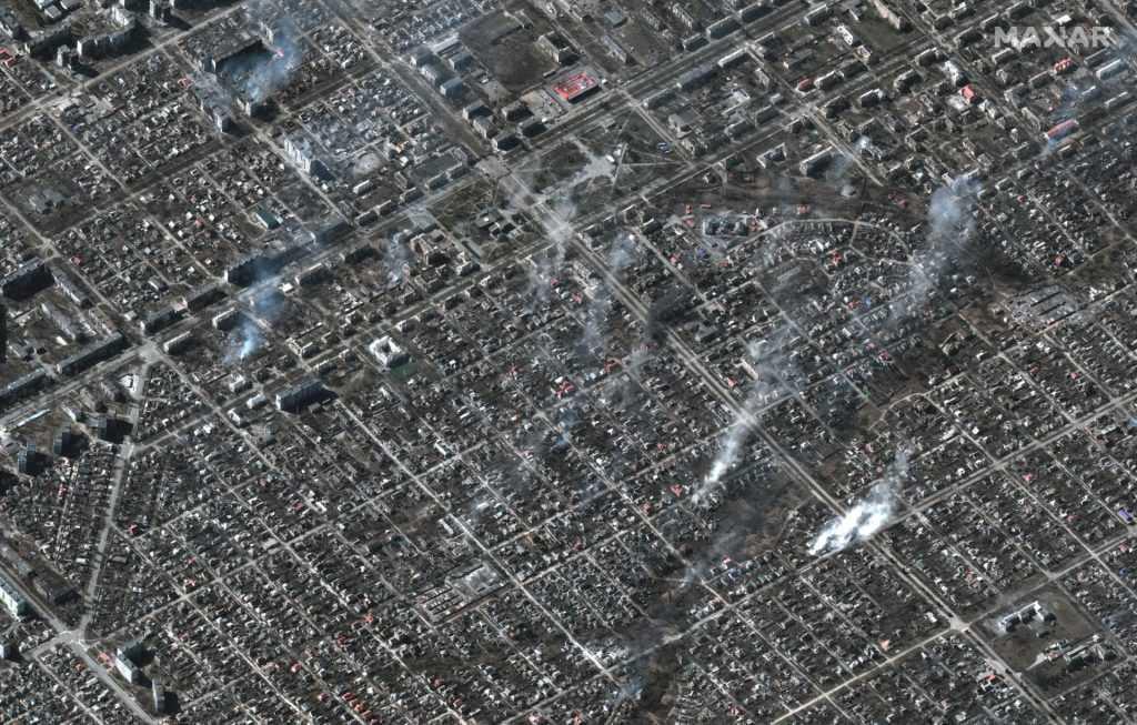 This Maxar satellite image taken and released on March 22, shows an overview of burning buildings in the Livoberezhnyi district of Mariupol, Ukraine. Photo: AFP
