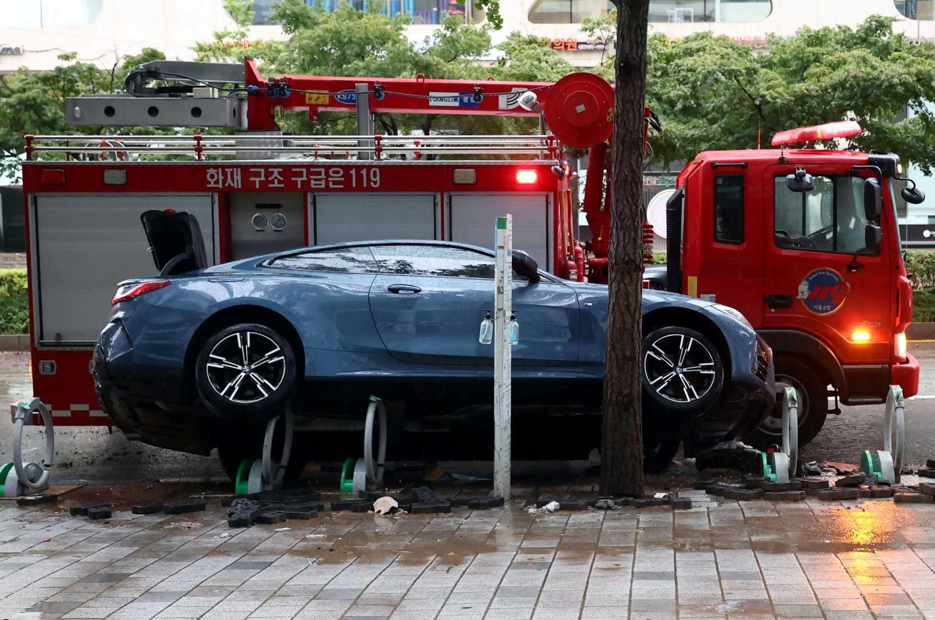 A car damaged by flood water is seen on the street after heavy rainfall at Gangnam district in Seoul on Aug 9. Photo: AFP 